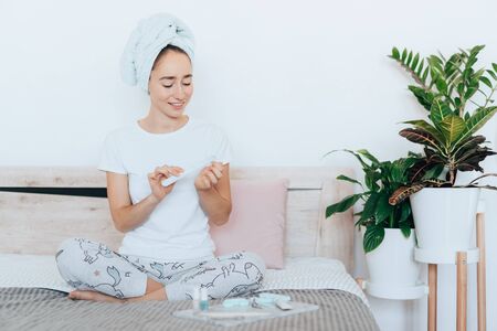 Girl makes a manicure at home.の写真素材