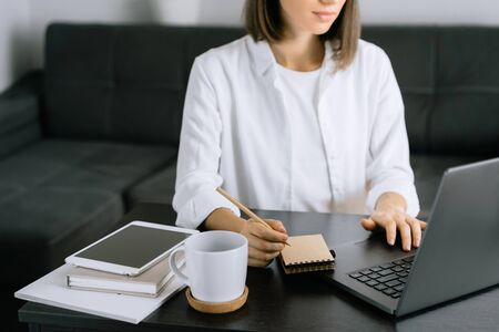 Woman using laptop at workplace in officeの写真素材