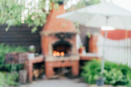 Defocused outdoor scene with back light representing outdoor cooking, summer gathering, BBQ, grill in the garden.の写真素材