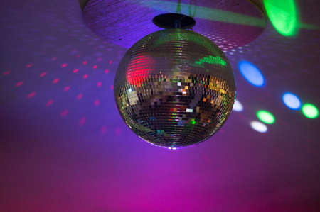 Silver disco ball in purple lightの写真素材