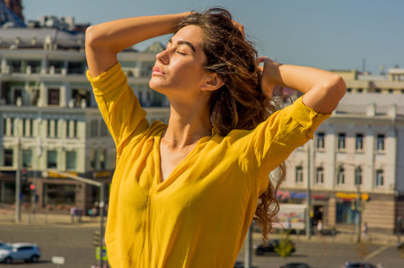 A girl with her eyes closed enjoying the sun's raysの写真素材