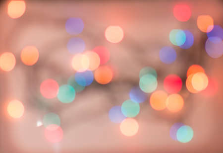 Romantic background. Beautiful bokeh on pink background. Abstract defocused Christmas garland lights.の写真素材