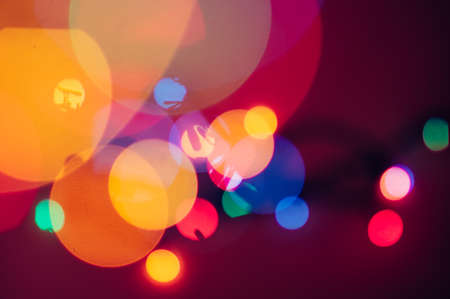 Christmas garland lights bokeh. Defocused New Year sparkles. Colorful bachground.の写真素材