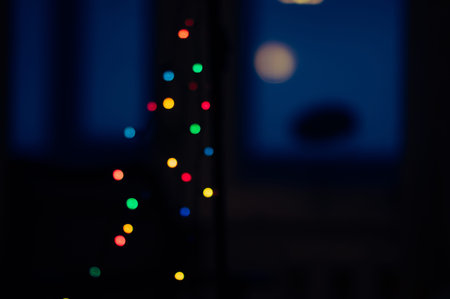 Abstract New Year background. Defocused colorful garland lights on black and blue background