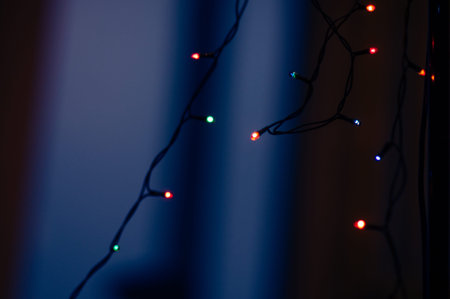 Abstract garland lights on black and blue backgroundの写真素材