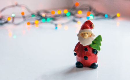 Santa Claus and colorful garlands. Beautiful New Year and Christmaas composition. Background for congratulations with copy space.の写真素材