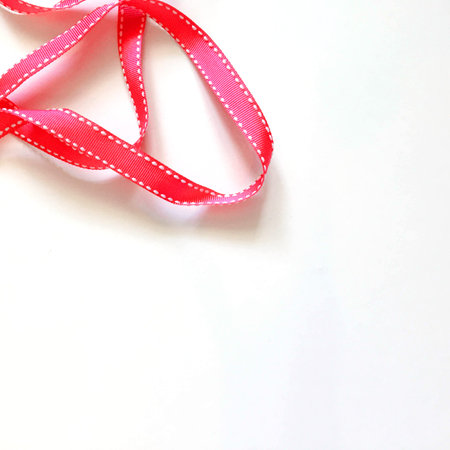 Red ribbon on white backgroundの写真素材