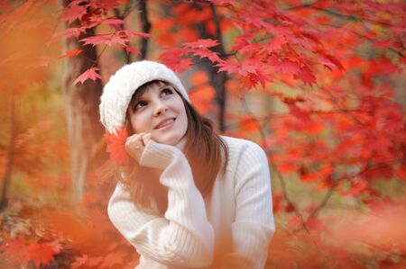 Young pretty woman in the autumn parkの写真素材