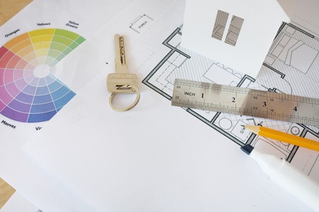 House remodel. The top view of a table of architects with the drawing of the house, with the paper model of the house, with a ruler and a pencil.の写真素材