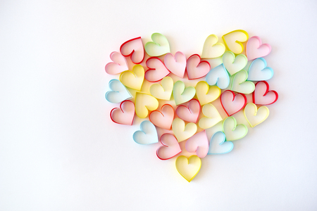 the multi-colored paper hearts on a white backgroundの写真素材
