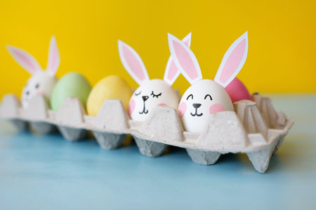 Happy Easter. Eggs with ears of rabbits, in an image of rabbits