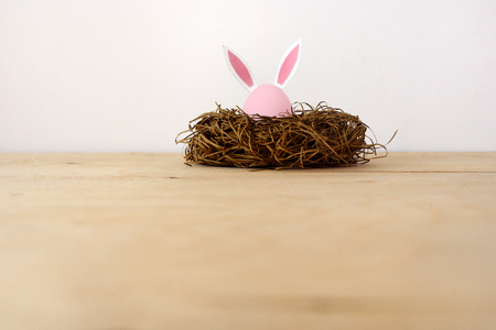 Happy Easter. Eggs with ears of rabbits in a nest on a white background.の写真素材