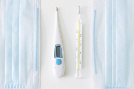 Glass and digital thermometers and face masks