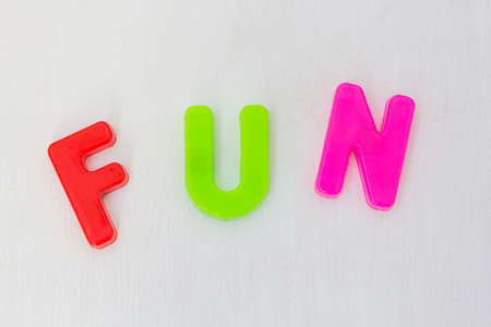 Colorful letters on white background. Kids plastic toy, learning alphabet and english words in language school. Text funの写真素材