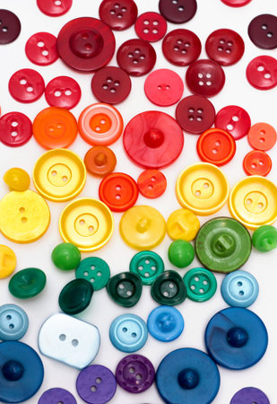 Group of plastic colorful buttons on white background. Rainbow colors red, yellow, green and blue...
