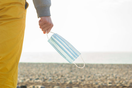 Breathing without mask.    Free life and safe travel concept. Man enjoys the sea