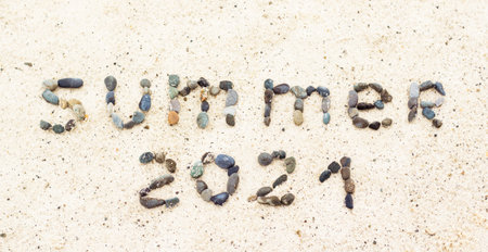 Word summer on the sand made from stones. Holiday and vacation concept.の写真素材