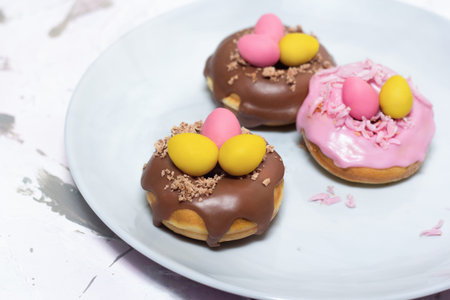 Easter dessert chocolate eggs in the doughnut nest. Holiday food and decoration.