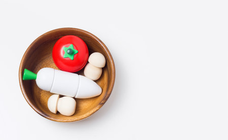 Wooden kids vegetable toys on White background. Healthy food concept. Game for development, eco and zero waste child productsの写真素材