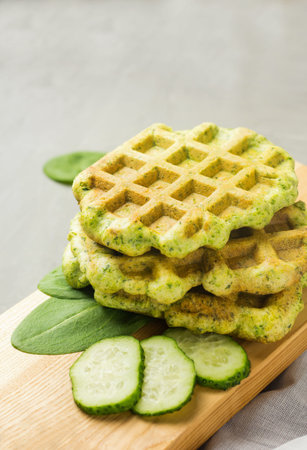Spinach waffles on wooden board. Helthy vegetarian cuisine. Homemade food.の写真素材