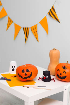 Holiday preparation and handmade party decor. Halloween indoor activity, pumpkin paintingの写真素材