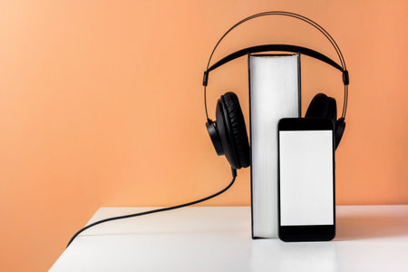 Headphones on book. Audiobook horizontal banner with copyspace. Online education and e-learning...