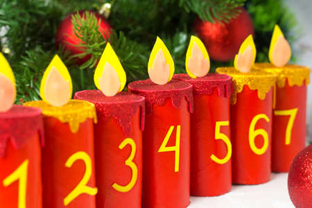 Handmade advent calendar with toilet paper tubes. Christmas candle craft. Seasonal eco activity for kids. Reuse concept.の写真素材