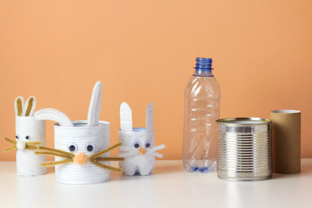 Reuse concept art from tin can, toilet tube, plastic bottle. Eco friendly bunny craft. Handmade...