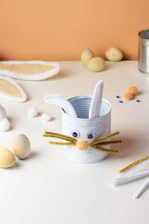 Reuse concept art from tin can. Eco friendly bunny craft. Handmade decoration easter rabbit. Kids DIY ideasの写真素材
