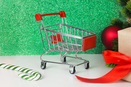 Christmas shopping. Empty grocery cart, Gift boxの写真素材