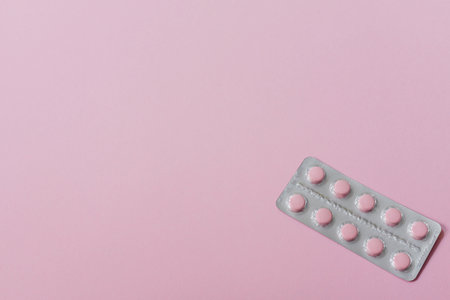 tablets pills on blur blister pack of tablets pills on pink background. prescription drugs. woman health concept. pharmaceutical industry. online pharmacy banner. Drugs packaging.の写真素材