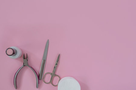 Ultraviolet lamp and manicure tools on a pink background. Gel polish manicure.の写真素材