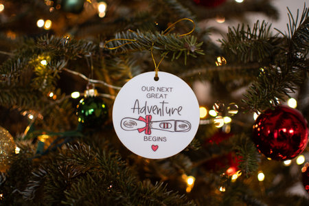 Pregnancy announcement decoration on a Christmas tree. Pregnancy concept. Christmas ornament on a tree pregnancy announcementの写真素材