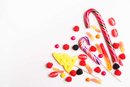 Colorful candies and jellies on the white background. Top view with copy spaceの写真素材