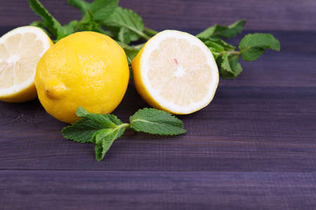 Ripe lemon with mint on a dark background. Space for textの写真素材