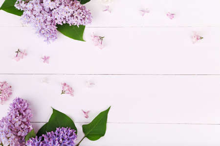 Beautiful white and violet lilac flowers on white wooden. Flat lay, top view with copyspaceの写真素材