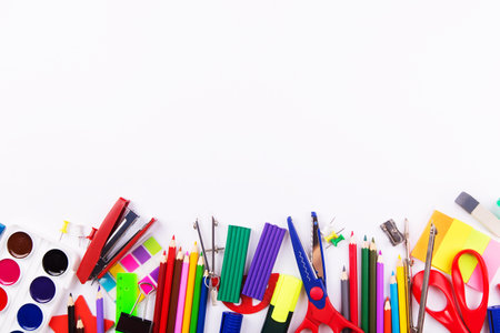 Various school supplies on a white background. Top view with copyspace