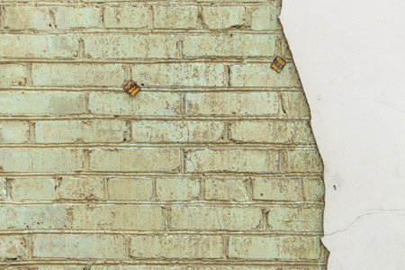 Textured old wall made of concrete and bricks. Combination of two textures. Grunge background.の写真素材