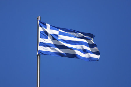 Flag of Greece on flagpole in sun