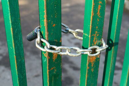 Lock on chain closed street fence outdoorsの写真素材