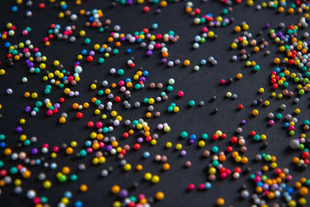 Colorful sugar sprinkles on black background, closeup. Space for textの写真素材