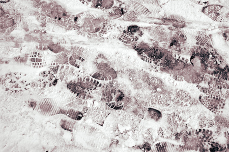 Traces of human shoes in the winter on snow.の写真素材