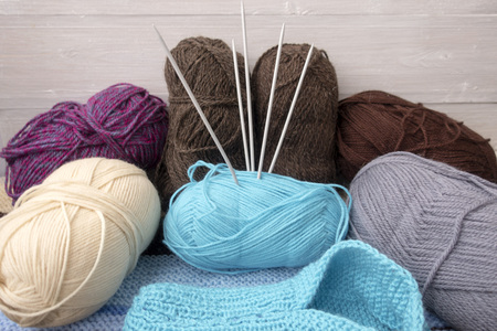 Knitting needles, multi-colored yarn and knitted sock.の写真素材