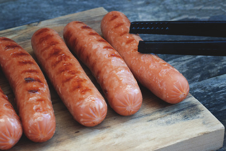 Grilled sausages close-up located on a wooden surfaceの写真素材