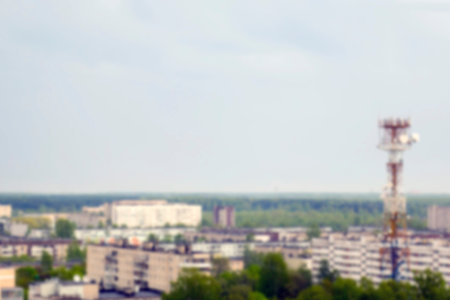 Abstract and blurred small city, buildings, trees and sky, cloudy weather