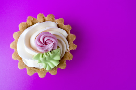 Cake basket of short pastry cream closeup on a purple background and copy spaceの写真素材