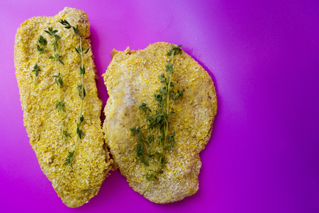 Meat schnitzel in breading close-up on a pink backgroundの写真素材