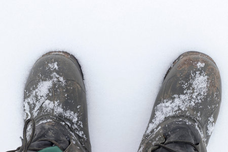 Feet in winter shoes for fishing in the winter on the snow.