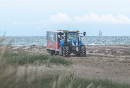 Tourists in the Sandormen. People and tractor transport at Skagen beach in Denmarkのeditorial素材