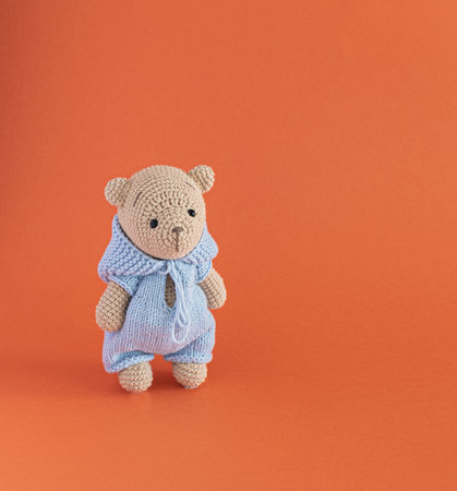 teddy bear toy on a orange backgroundの写真素材